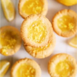 Lemon Bar Cookie Cups in a plie on a white background.