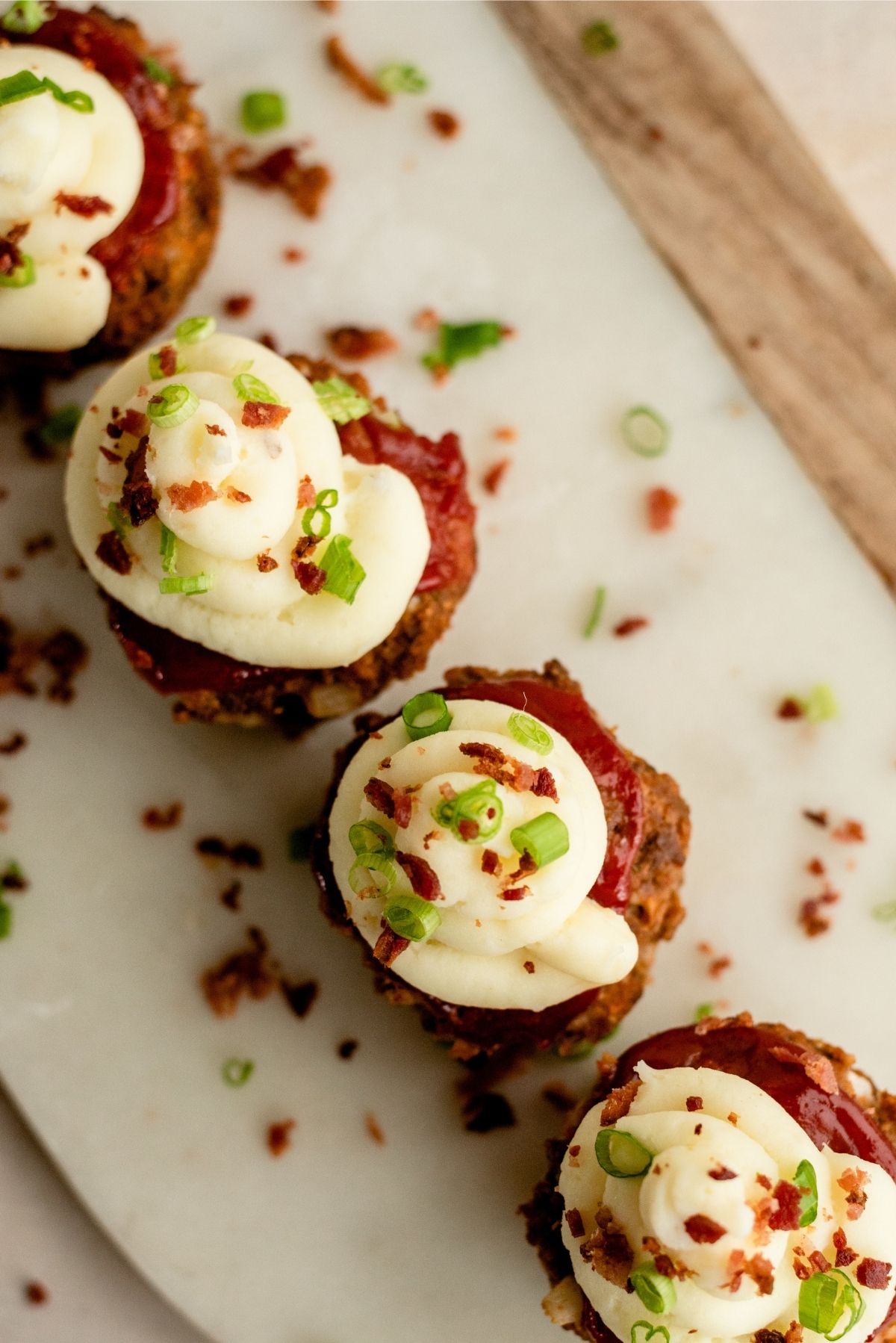 Tops of Meatloaf Cupcakes sprinkled with bacon and green onions