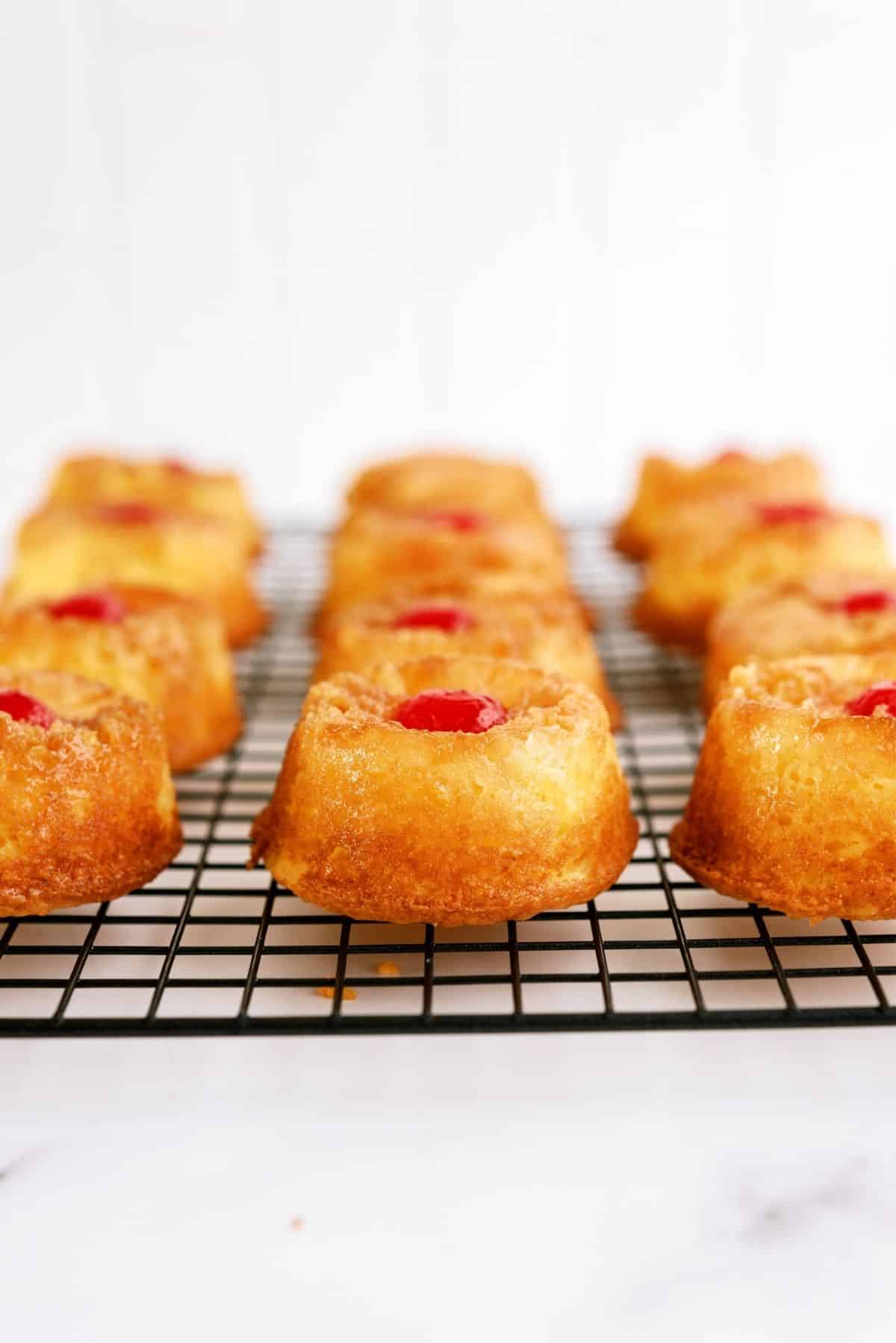 Mini Pineapple Upside Down Cakes on a cooling rack