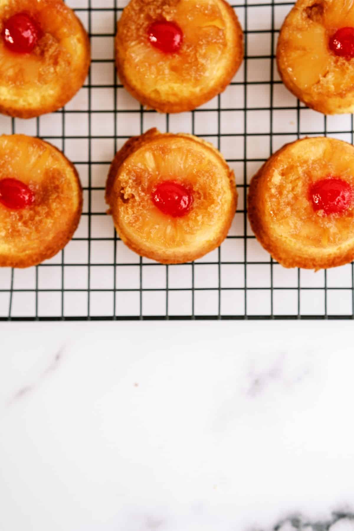 Mini Pineapple Upside Down Cakes on a cooling rack