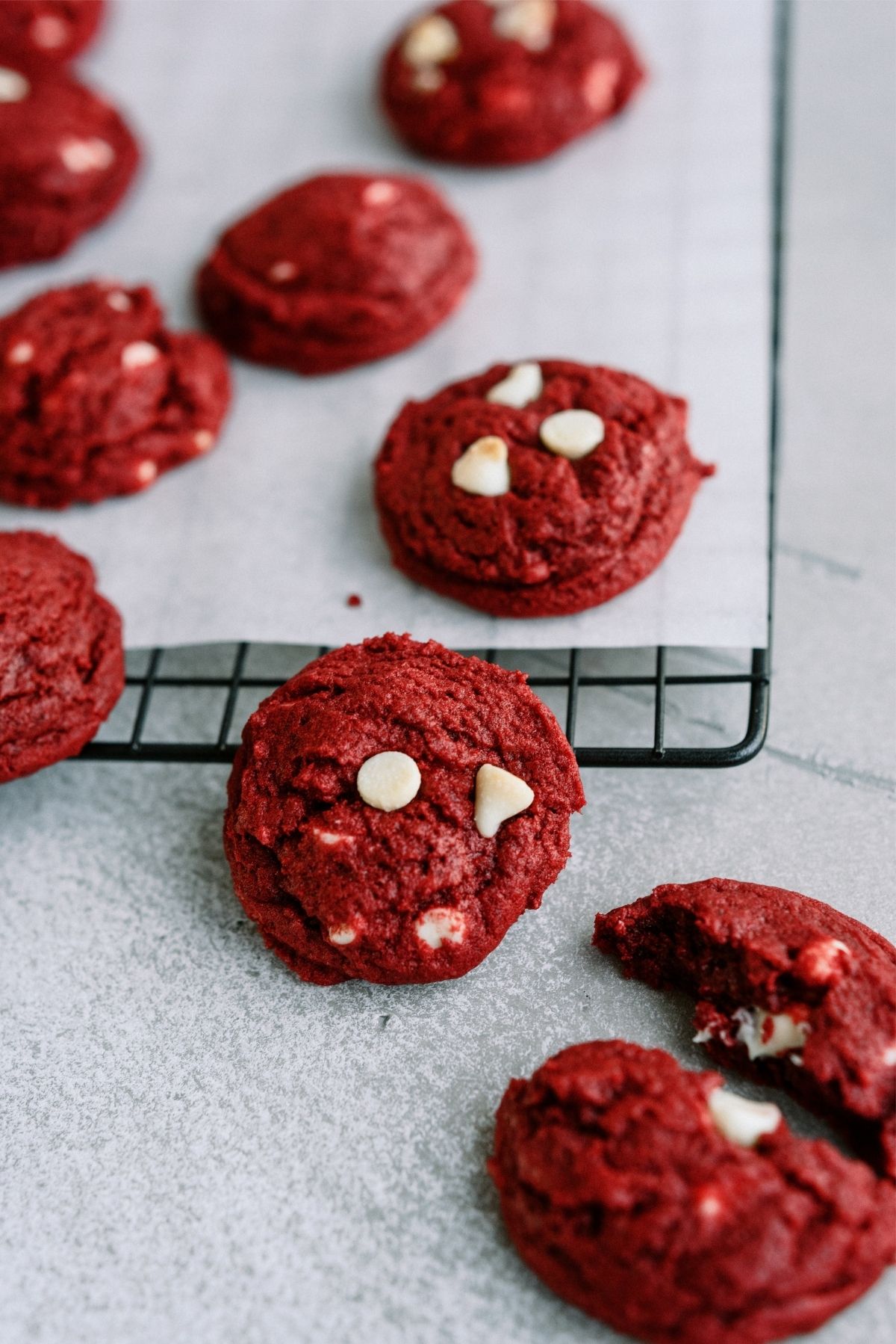 Red Velvet White Chocolate Chip Cookies on a cooling rack