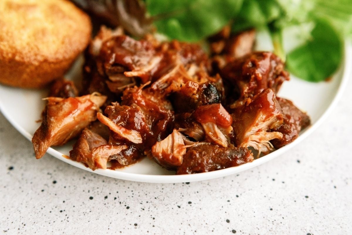 Slow Cooker BBQ Ranch Ribs on a plate served with salad and bread