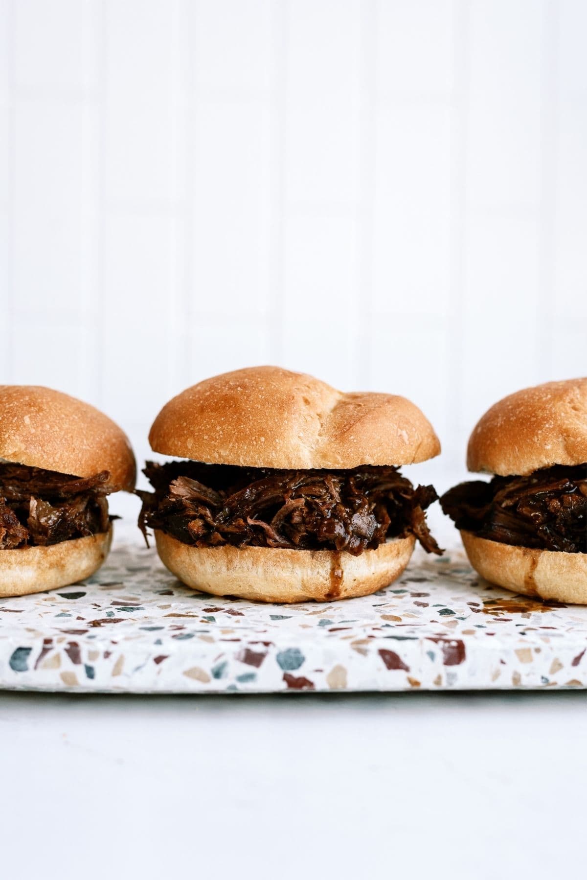 Slow Cooker Italian Roast Beef Sandwiches on a cutting board