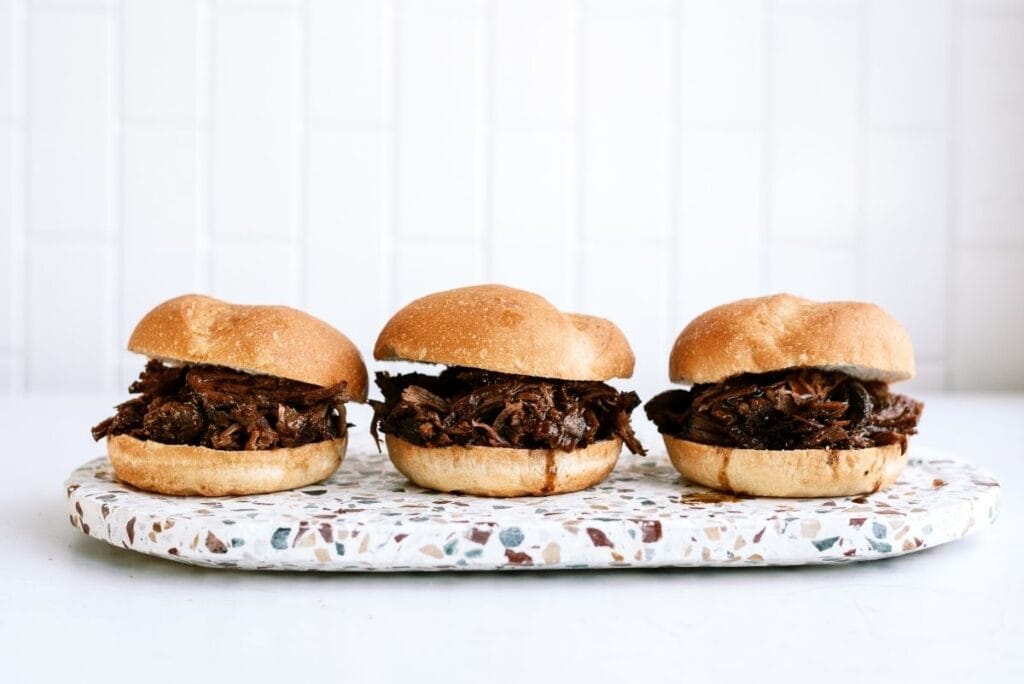3 Slow Cooker Italian Roast Beef Sandwiches on a plate.