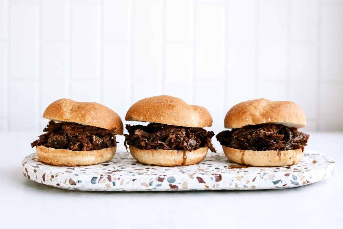 Slow Cooker Italian Roast Beef Sandwiches lined up in a row