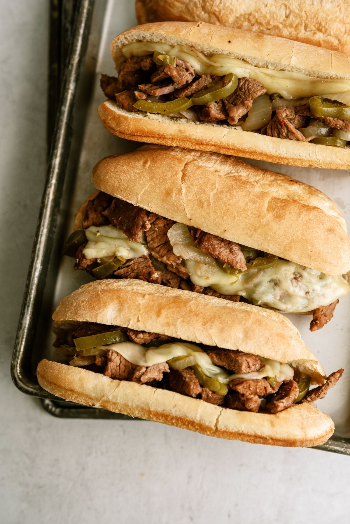 Slow Cooker Philly Cheese Steak Sandwiches on a baking sheet