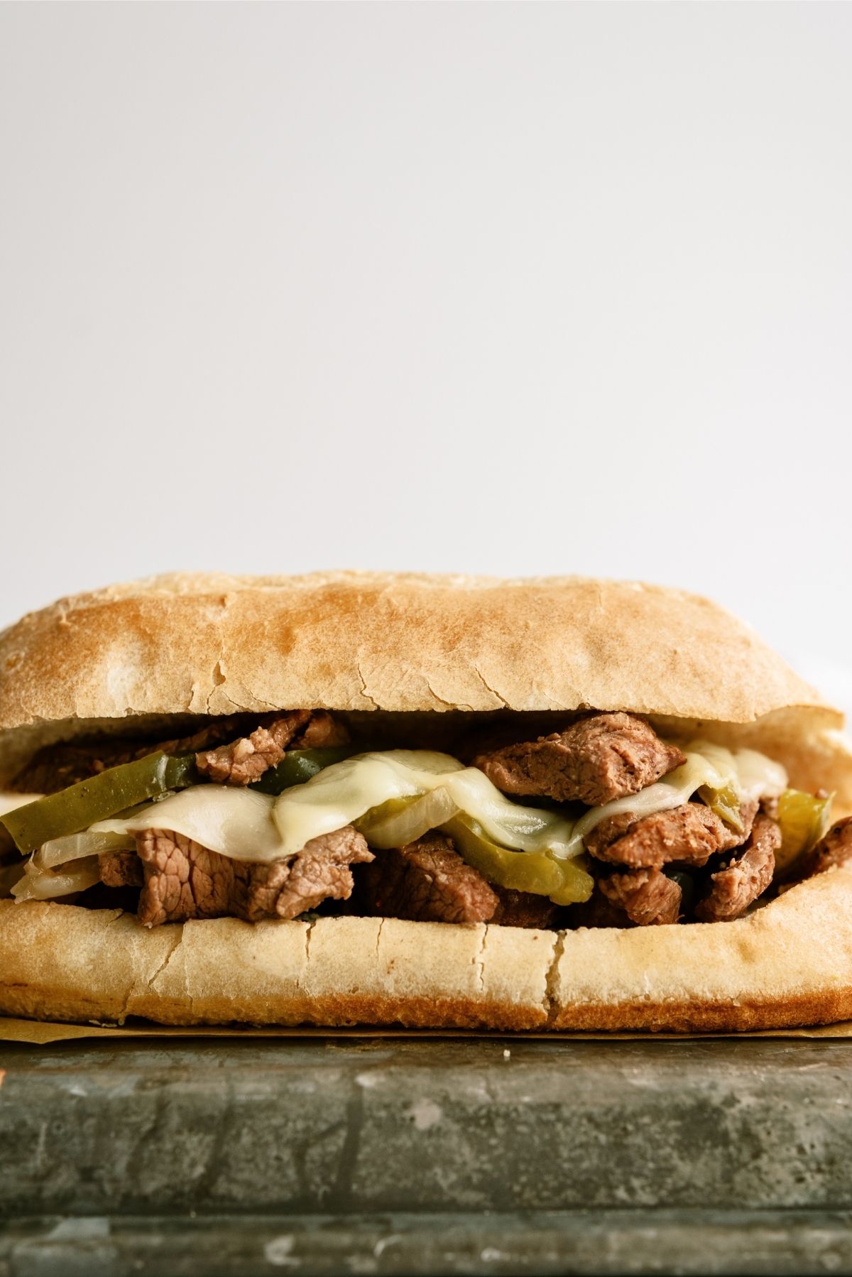 Slow Cooker Philly Cheese Steak Sandwich on top sheet pan