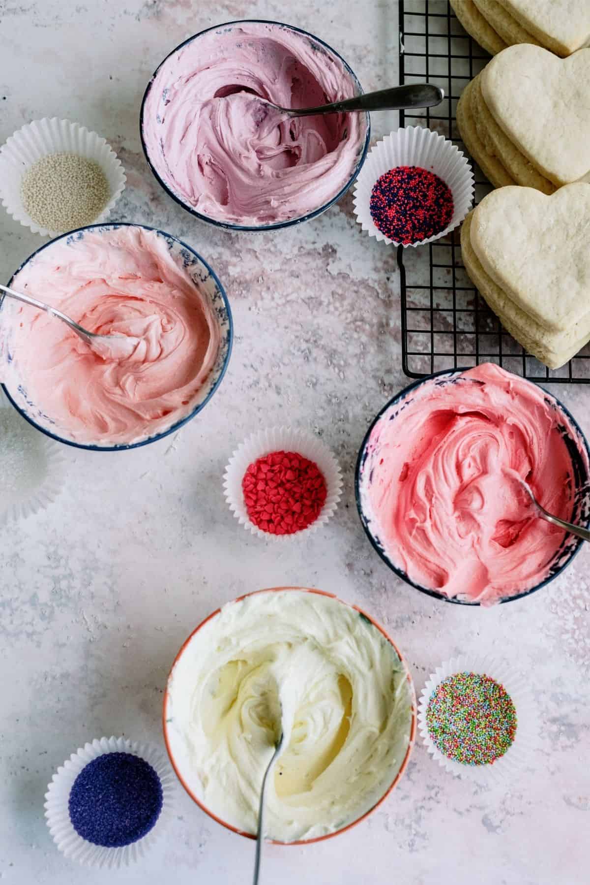 Buttercream frosting in different colors and sprinkles