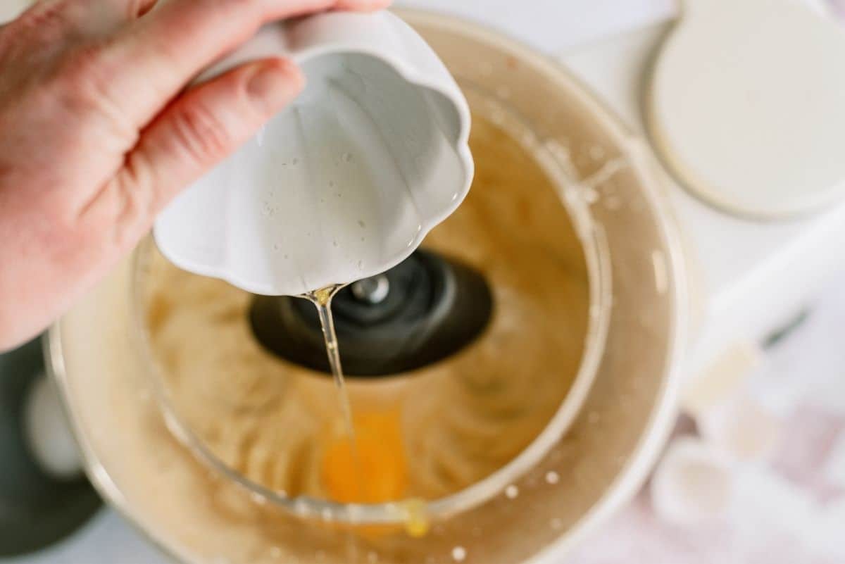 Adding eggs to the cookie dough mixture