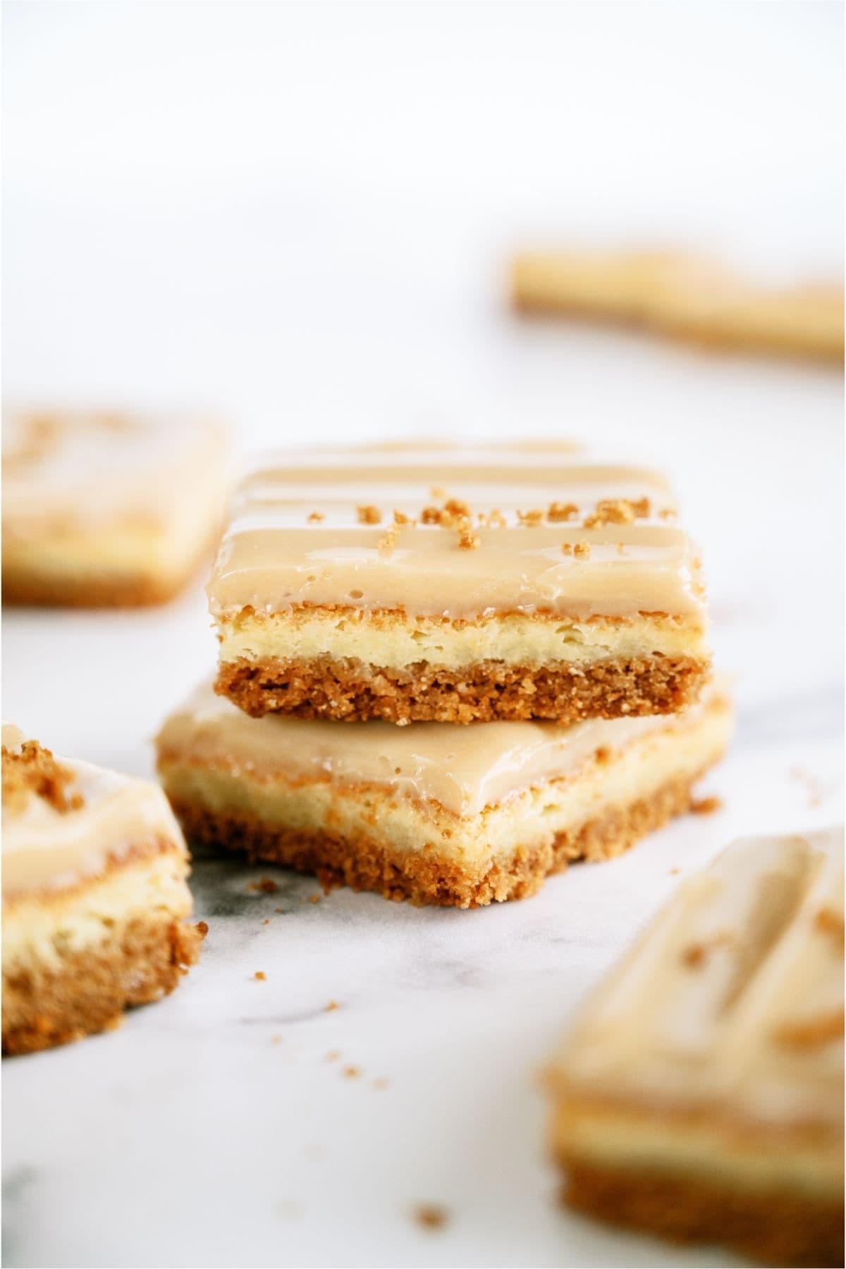 Two Caramel Cheesecake Bars stacked on top of each other.