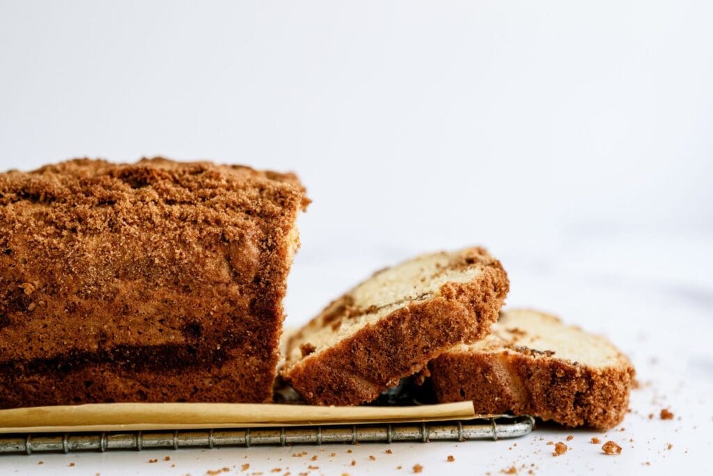 Side view of a loaf of Cinnamon and Sugar Quick Bread partially sliced.