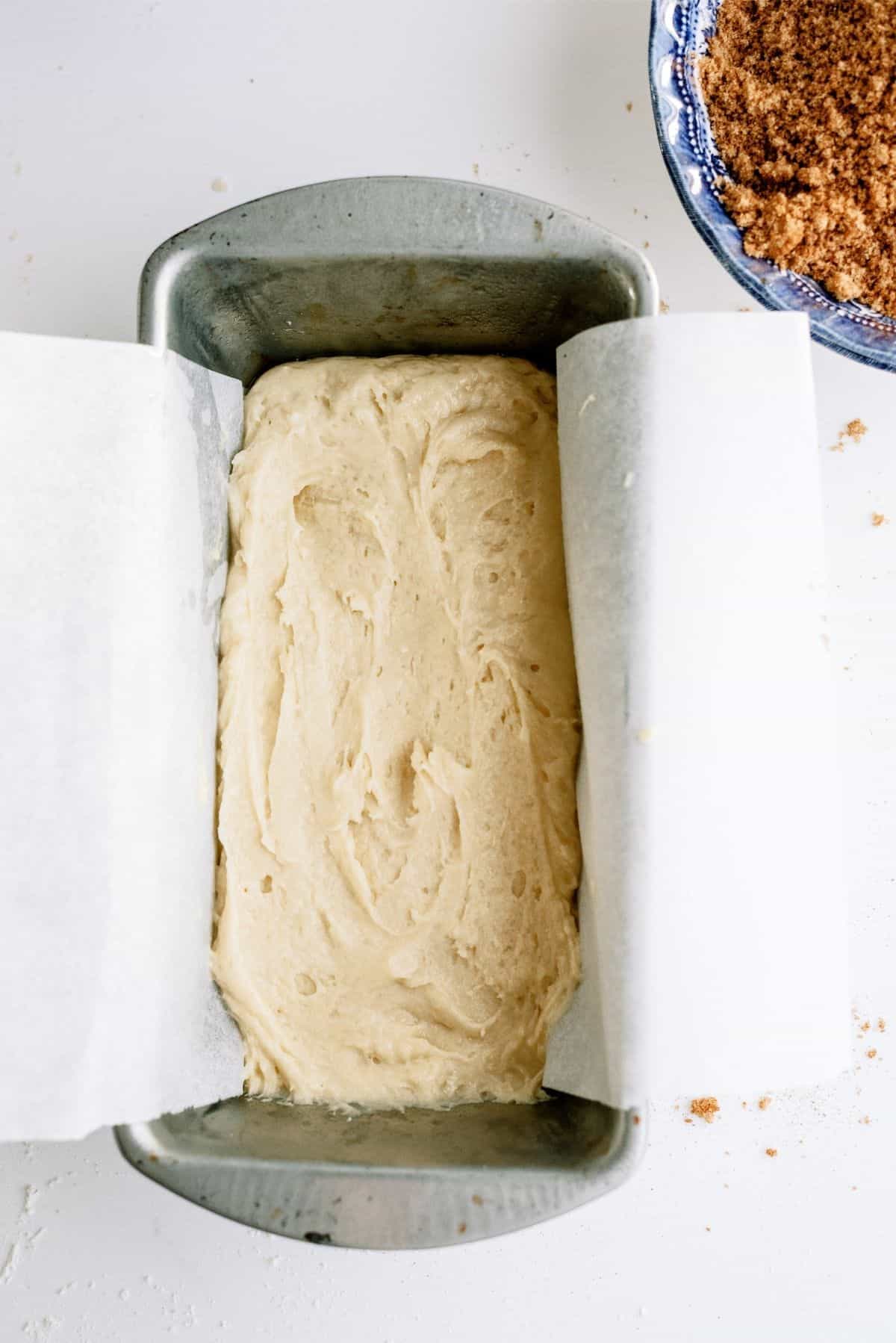 1.5 cups of batter poured into the bottom of the loaf pan