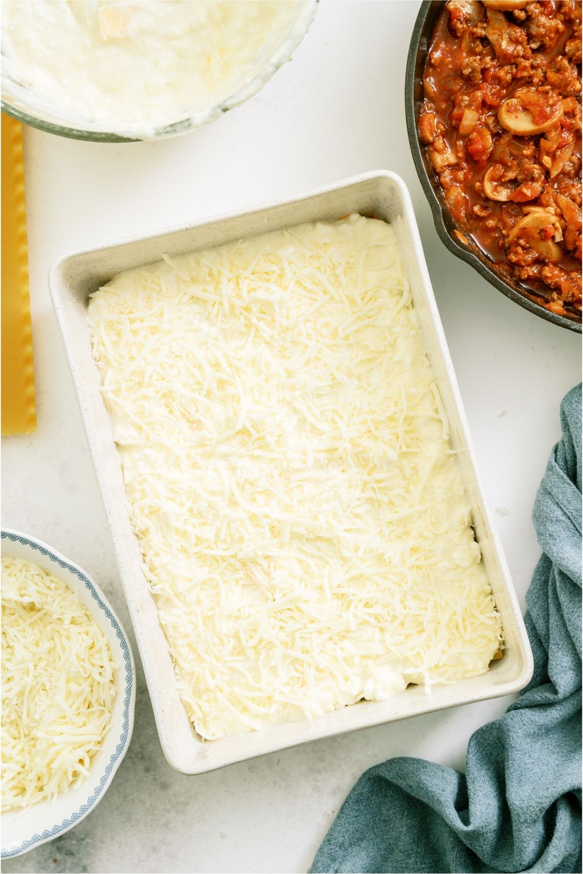 Cheese and egg mixture layered on top of noodles on dish.
