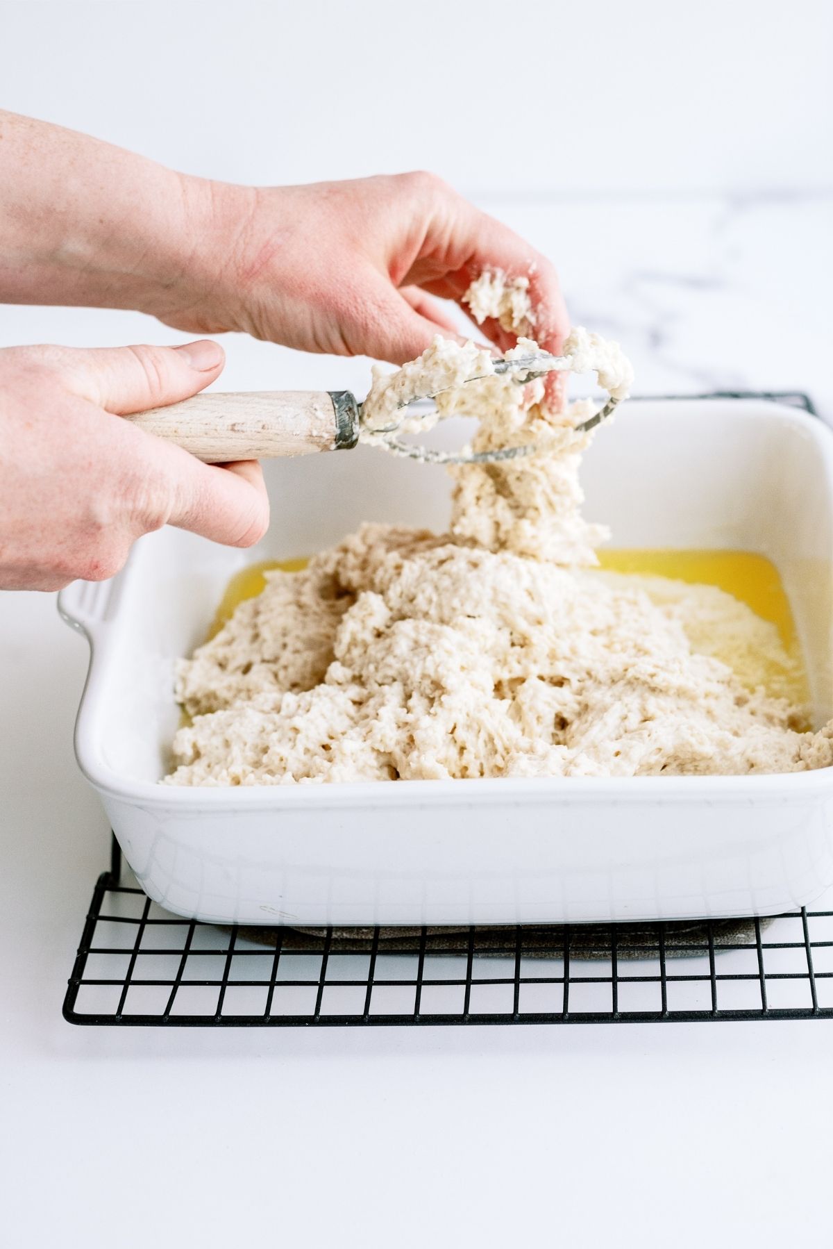 Spreading the biscuit dough into the prepared pan