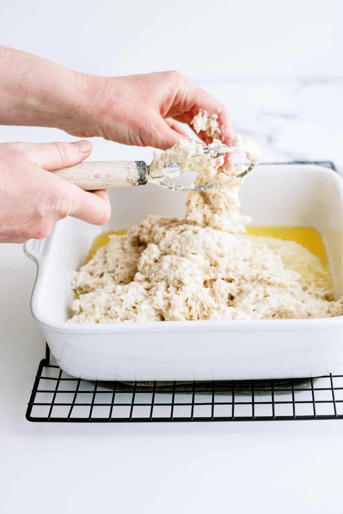 Spreading the biscuit dough into the prepared pan