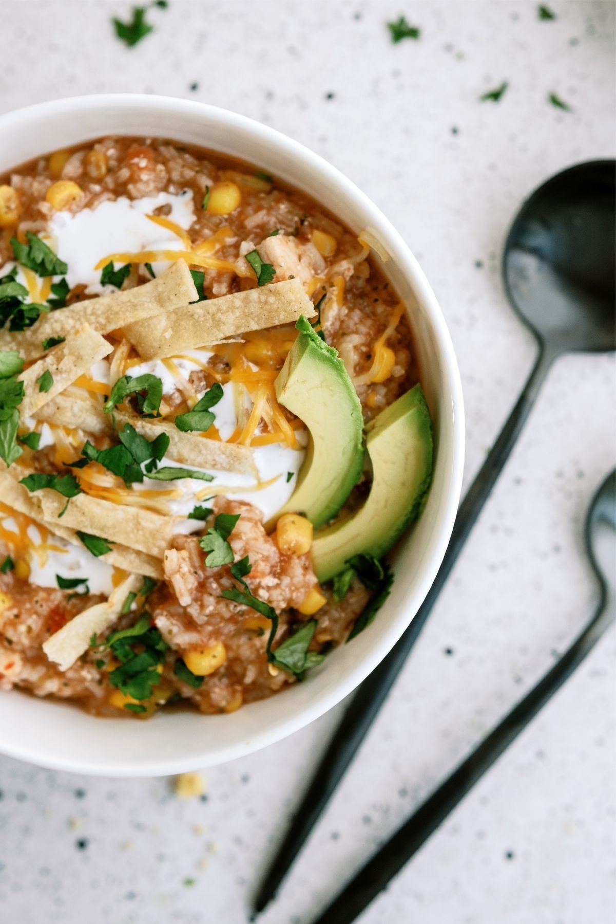 Hearty Chicken Tortilla Soup in a bowl with utensils