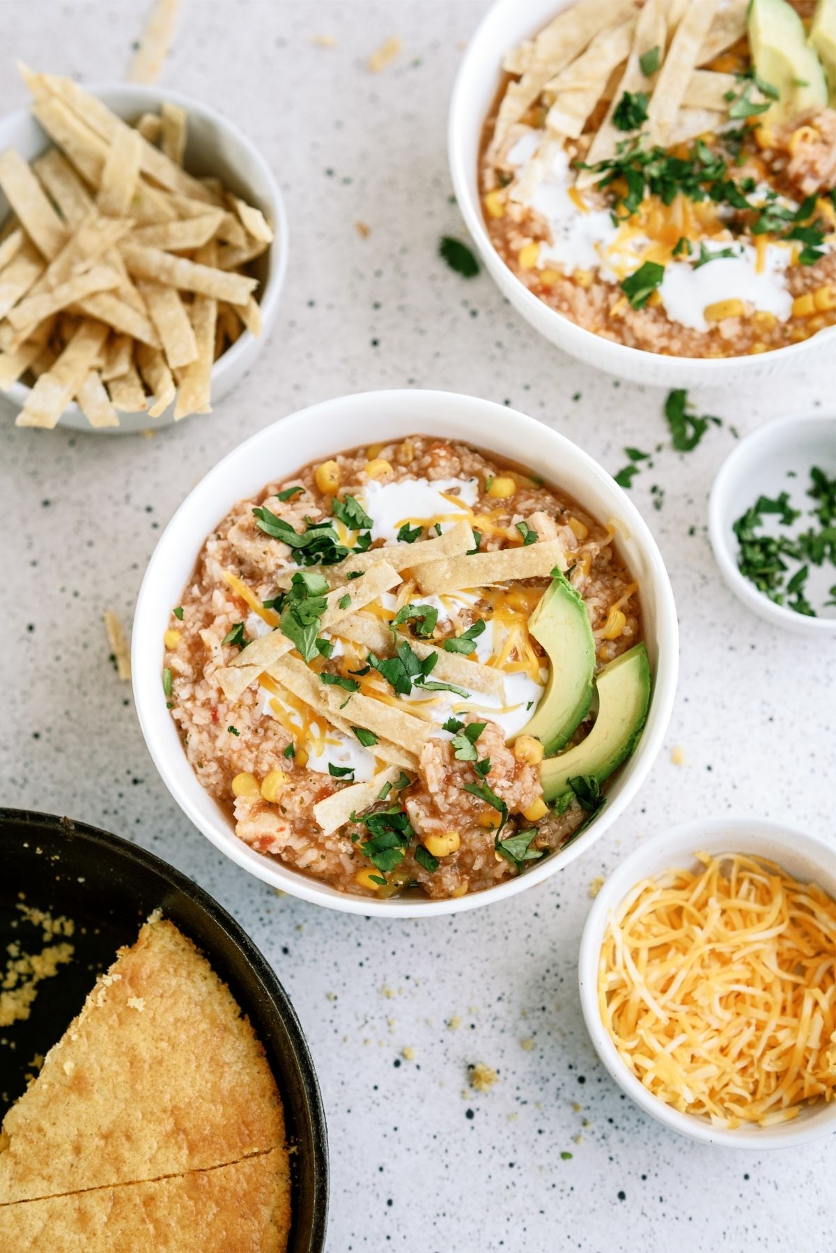 Hearty Chicken Tortilla Soup with tortilla strips and cheese on the side
