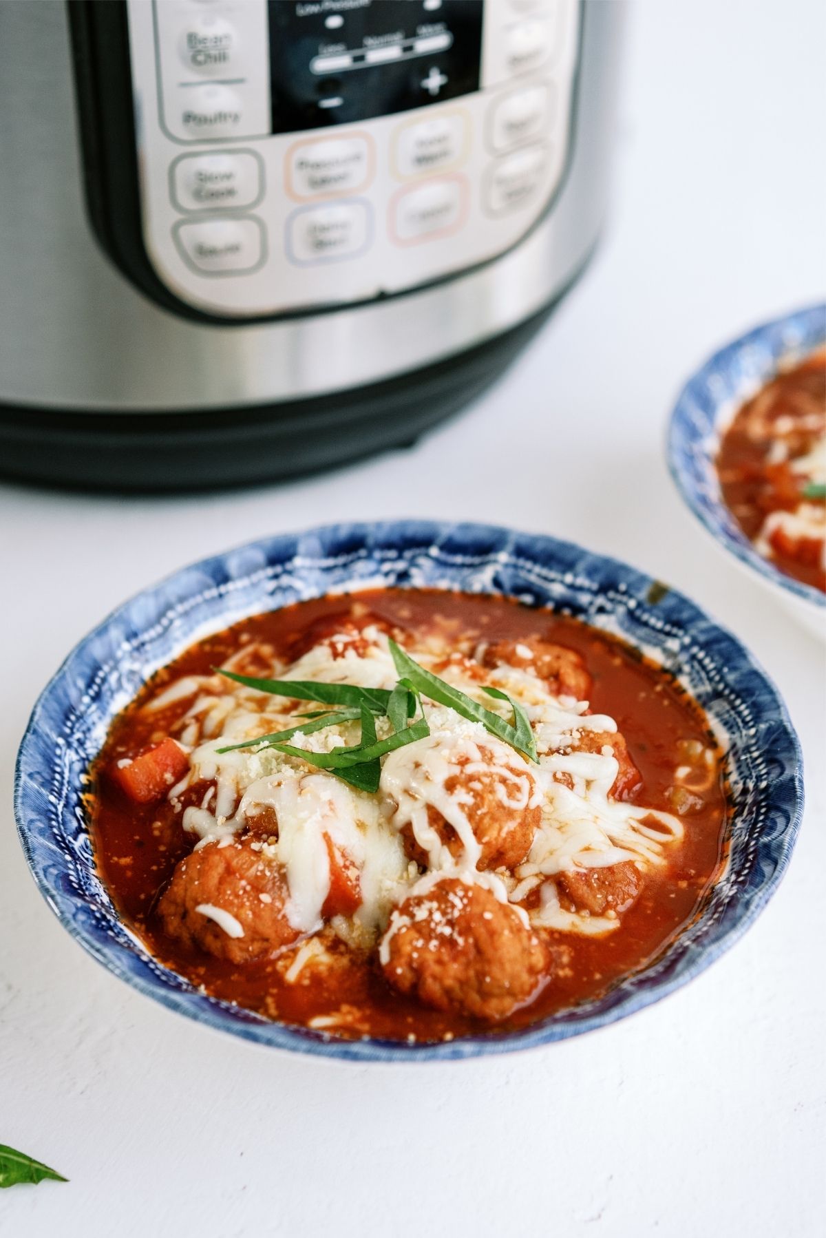 Instant Pot Dump and Go Meatball Soup in a bowl with an Instant Pot in the background