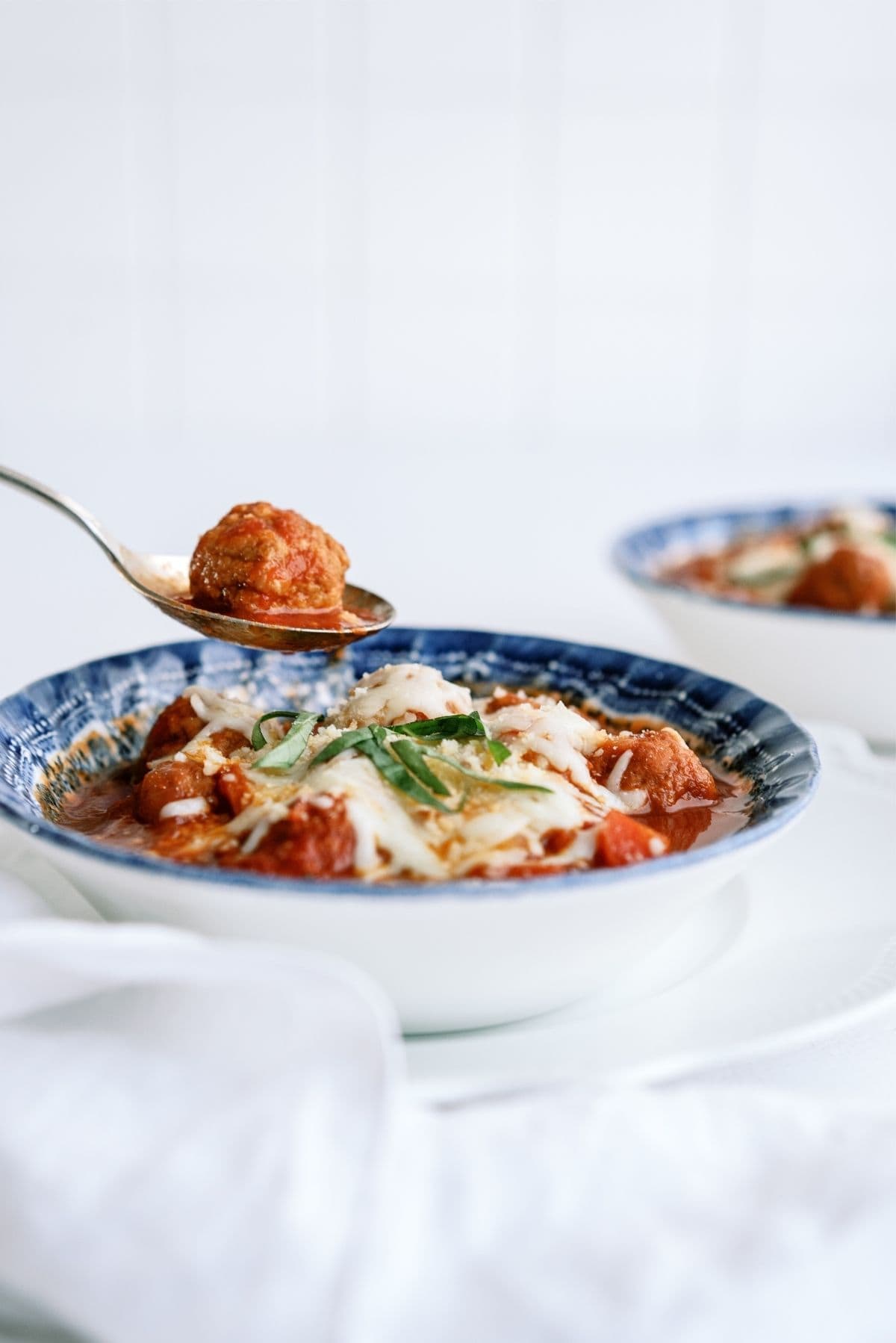 Instant Pot Dump and Go Meatball Soup in a bowl with a spoon holding a meatball