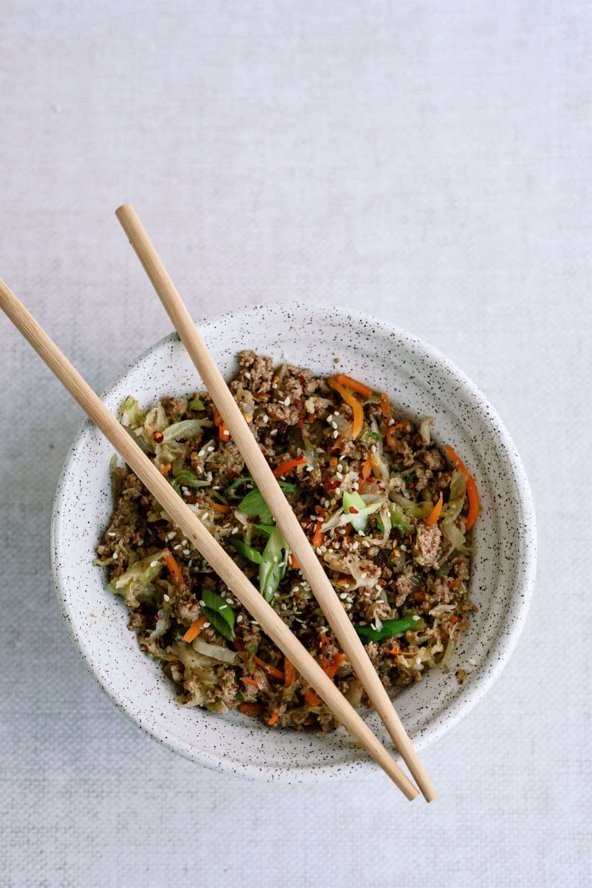 Instant Pot Egg Roll Bowls in a white bowl with chopsticks