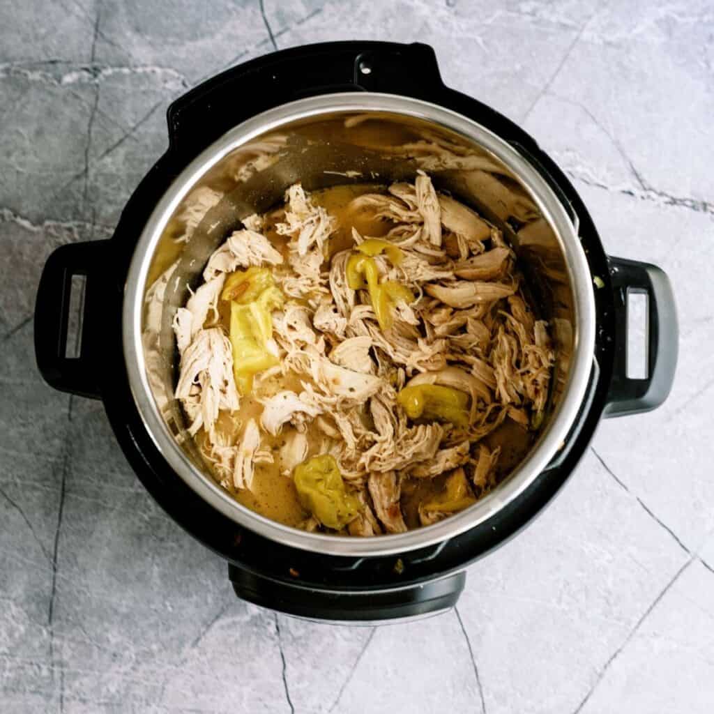 Instant Pot Mississippi Chicken shredded in the instant pot.