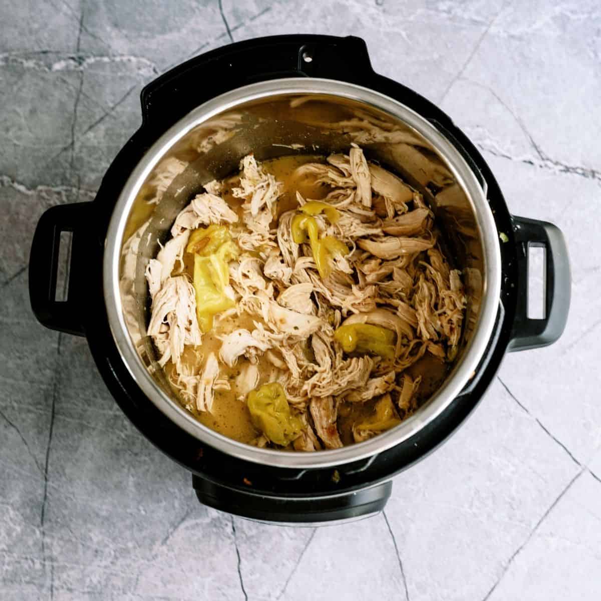 Instant pot full of Instant Pot Mississippi Chicken Sandwich mixture