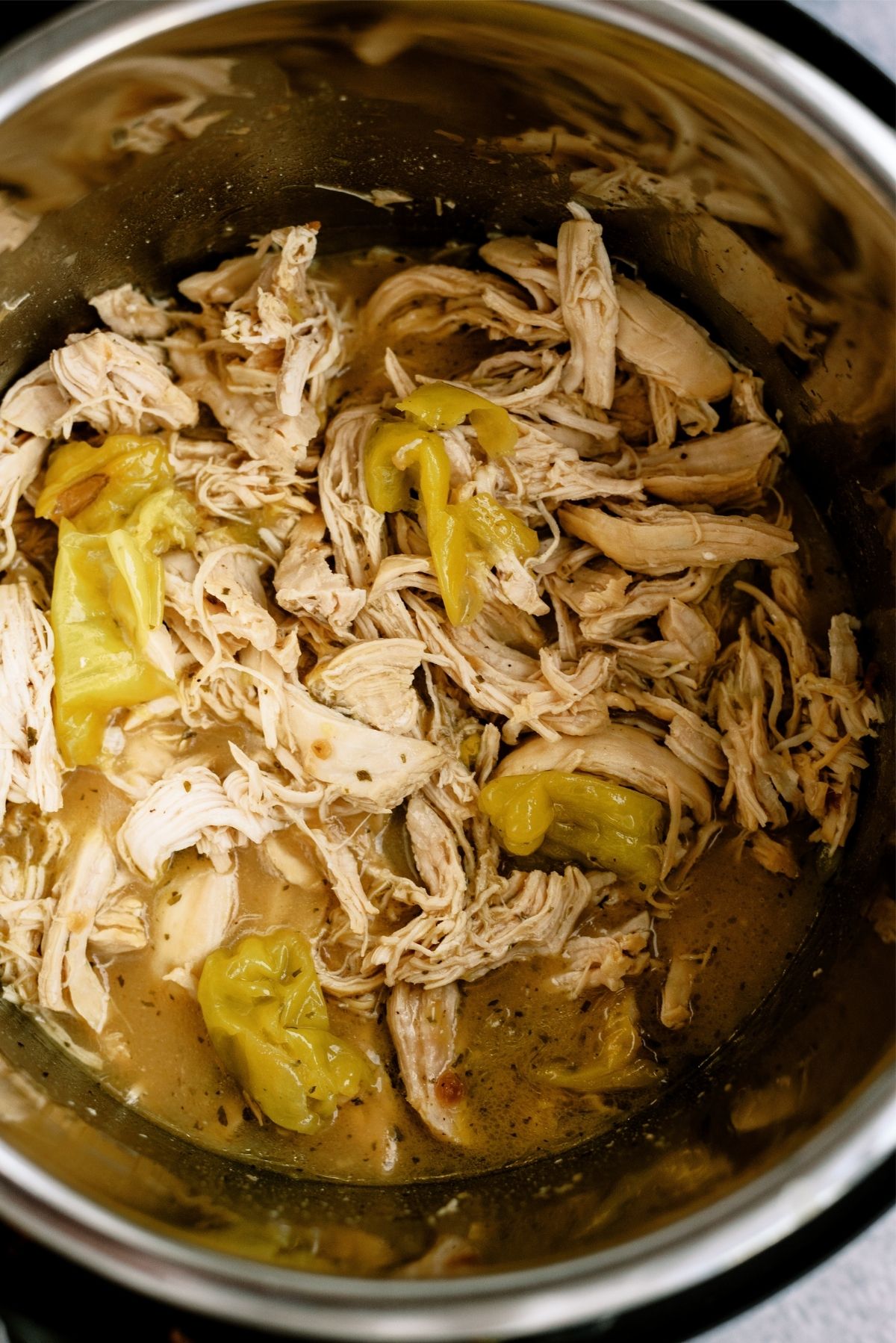 Close up of Instant Pot Mississippi Chicken Sandwich mixture inside of Instant Pot