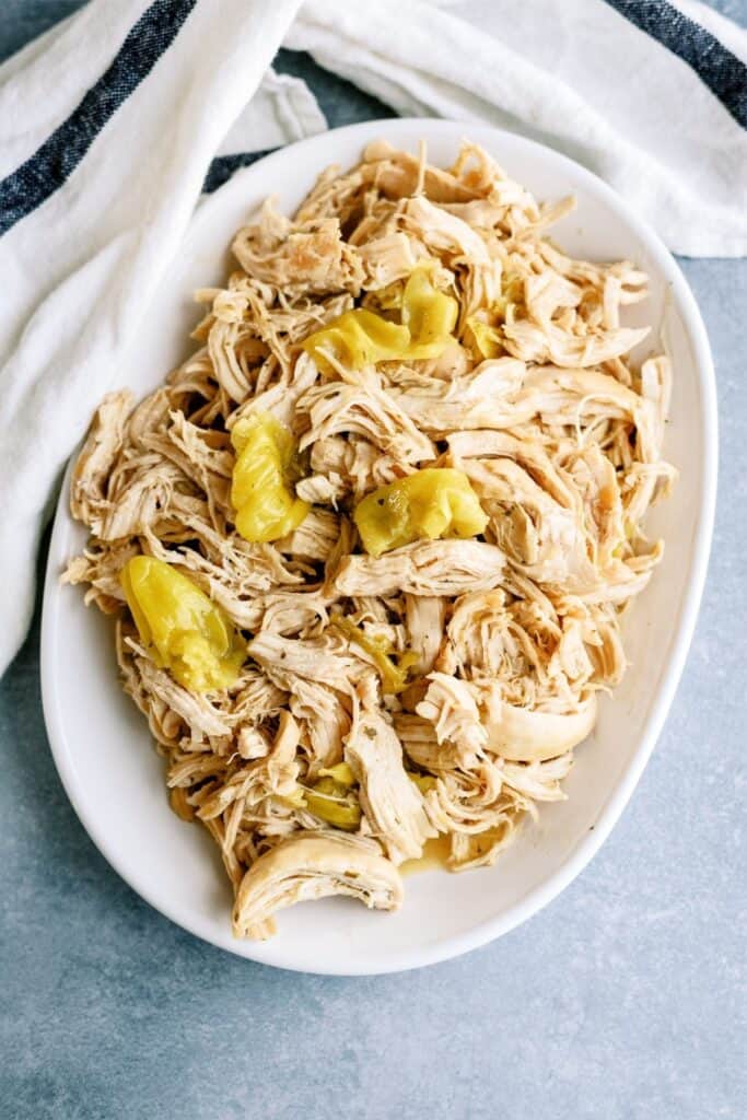 Instant Pot Mississippi Chicken shredded on a serving platter.
