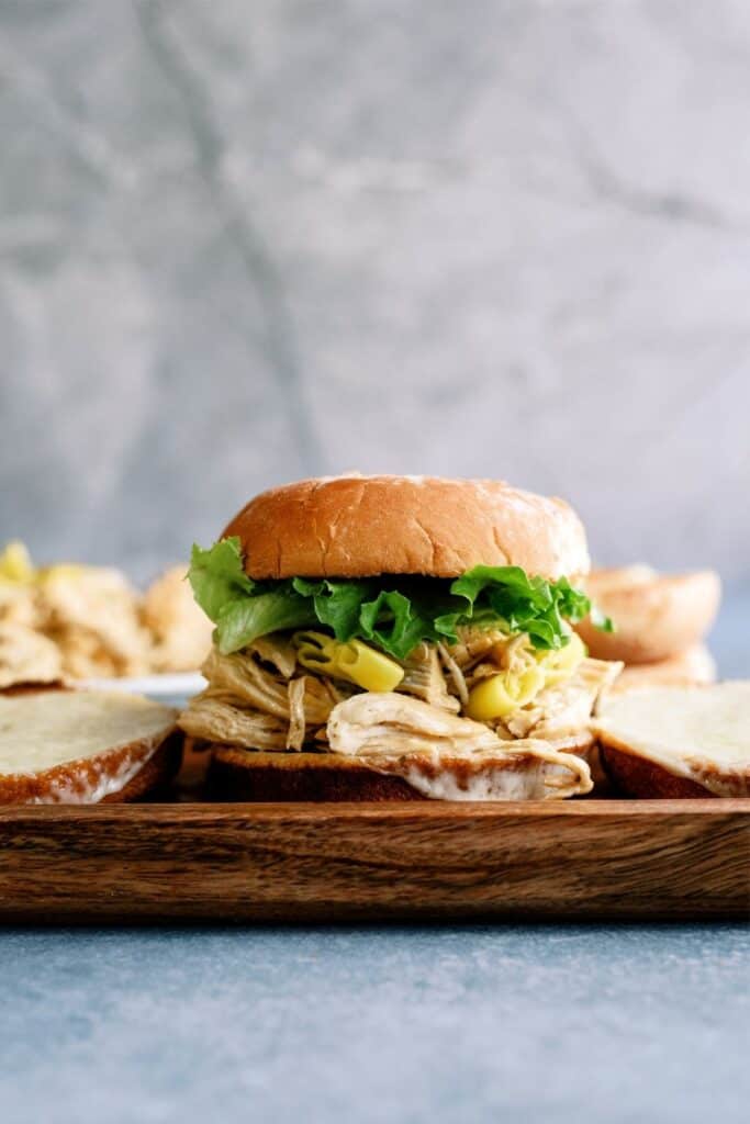 Instant Pot Mississippi Chicken Sandwich on a cutting board.