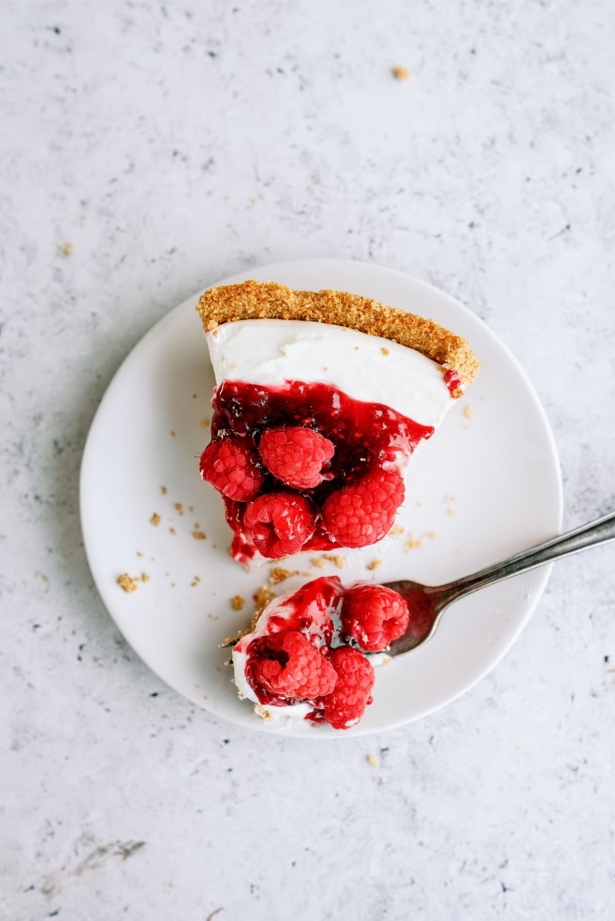 Slice of Raspberry Cream Cheese Pie on a plate with a fork