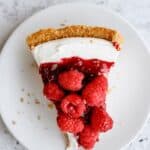 Top view of a slice of Raspberry Cream Cheese Pie on a plate.