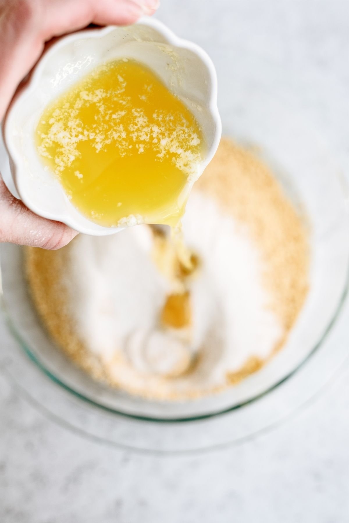 Graham cracker crumbs, sugar and melted butter in a glass bowl