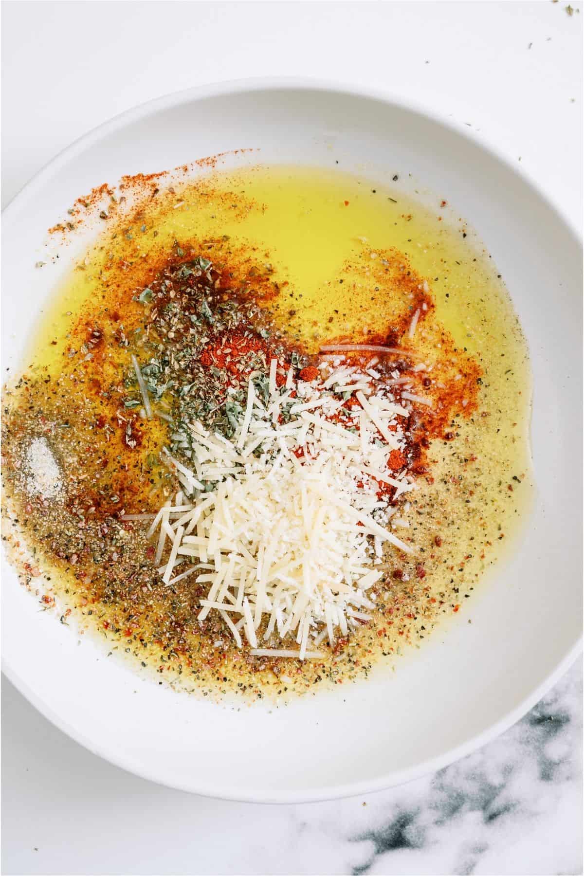 Mixture for Italian dressing in a white bowl.