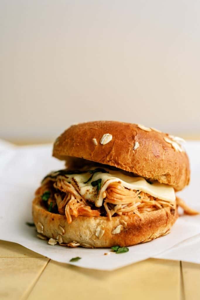 Slow Cooker Chicken Italian Sandwich on parchment paper.