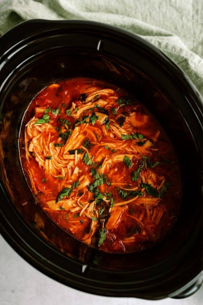 Slow Cooker Italian Chicken shredded in the slow cooker.