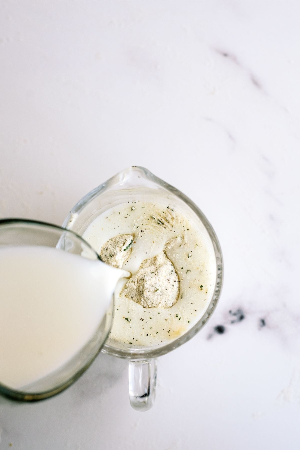 Milk poured into a bowl of ranch seasoning