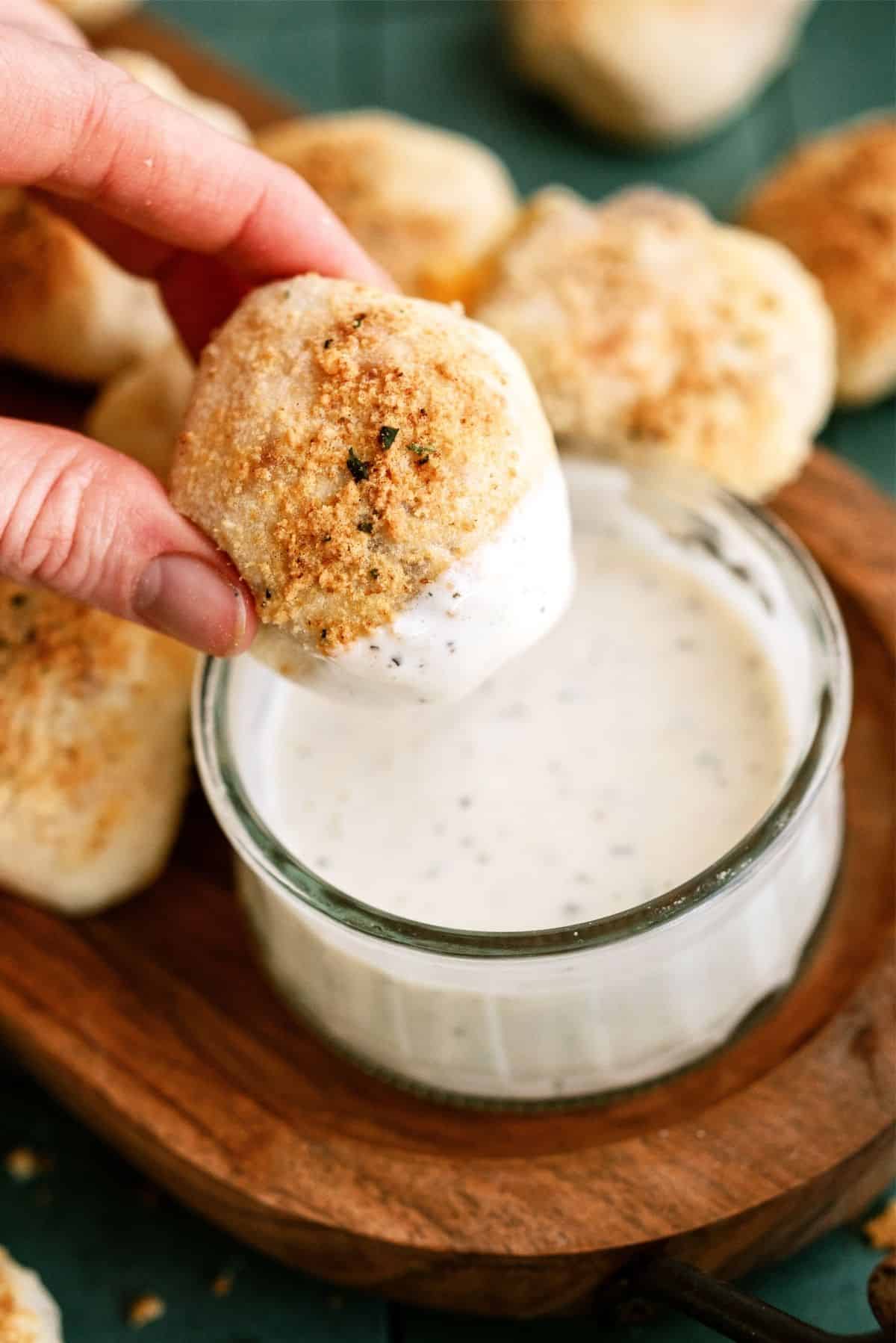 Chicken Bacon Ranch Pizza Rolls with one roll being dipped in ranch