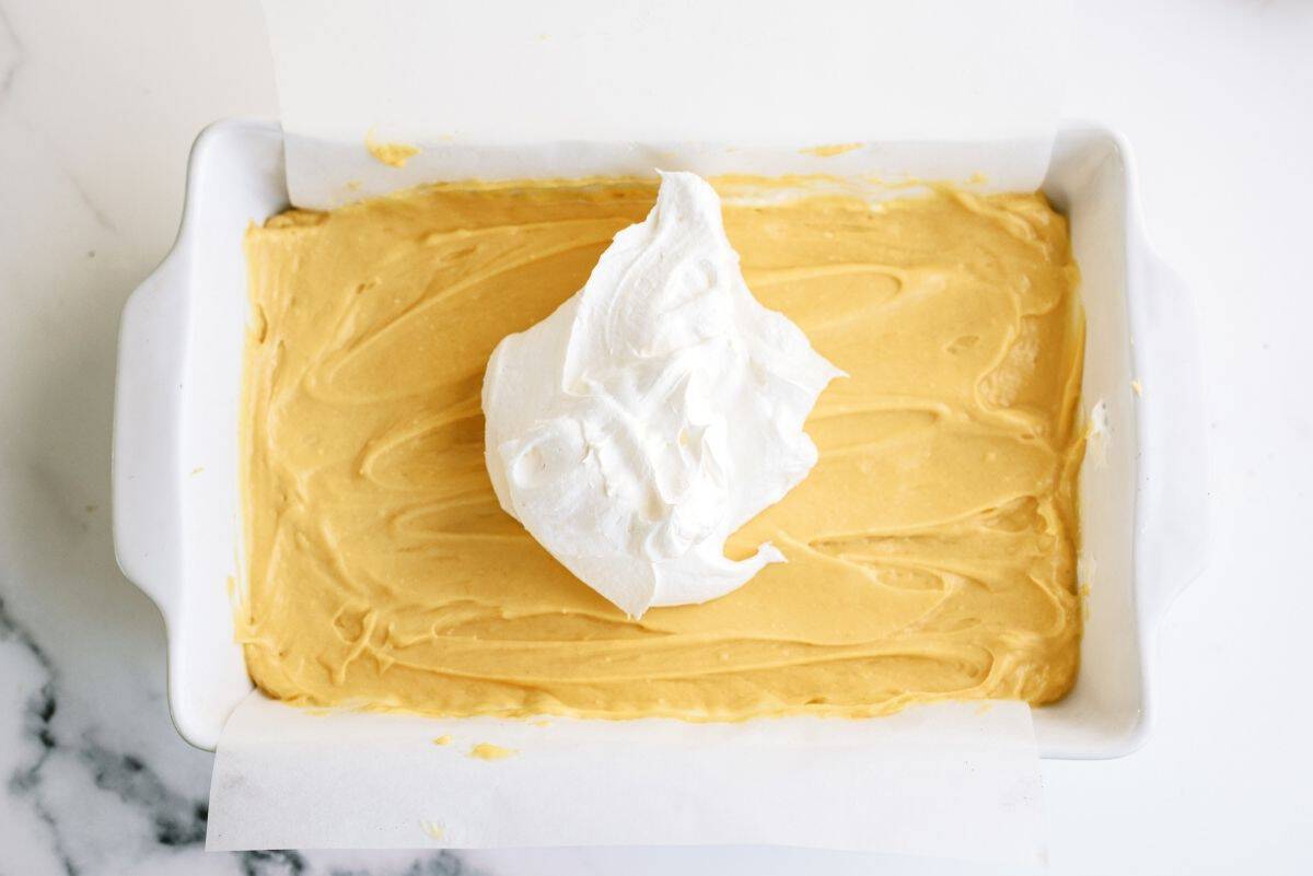 Peanut butter layer on top of cream cheese layer with a dollop of whip cream on top