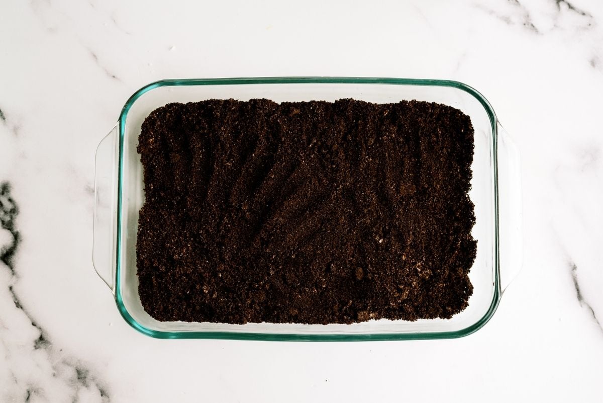 Crushed oreos in the bottom of a 9x13 baking dish
