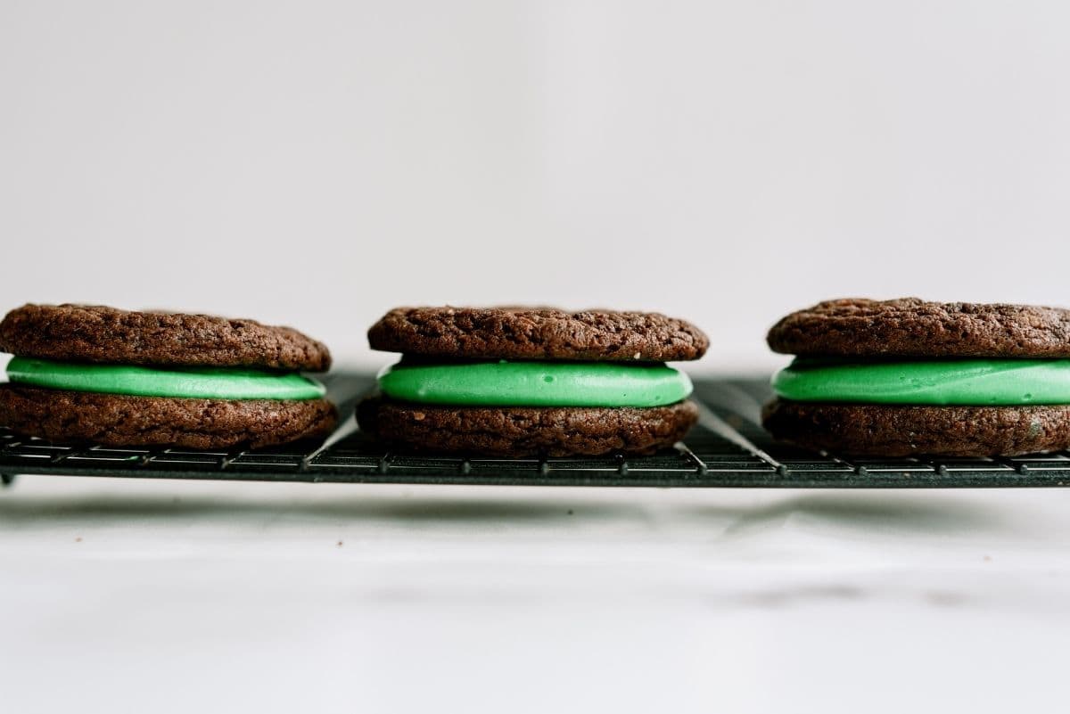 Grasshopper Sandwich Cookies on a cooling rack