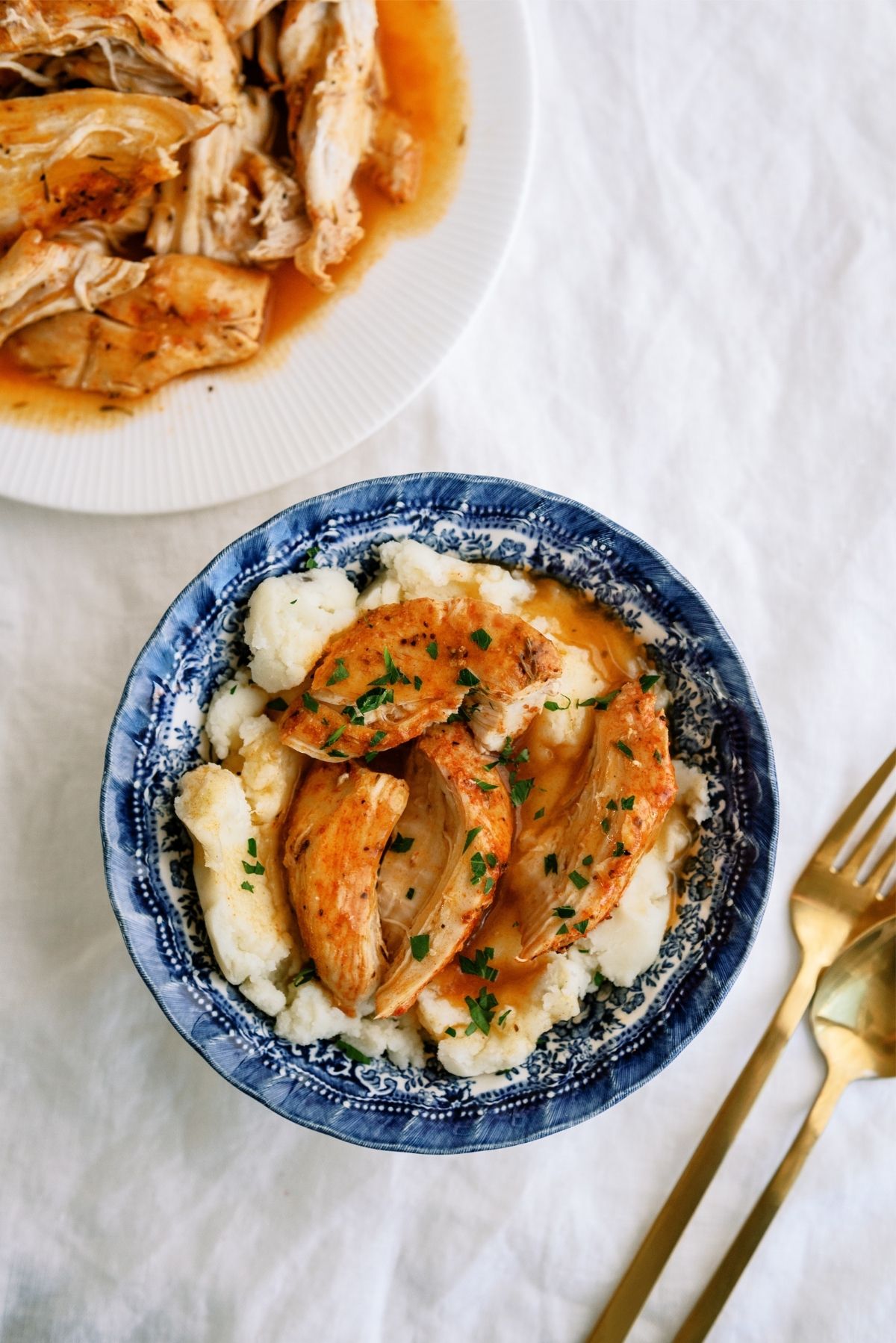Instant Pot Chicken and Gravy served over mashed potatoes in a bowl