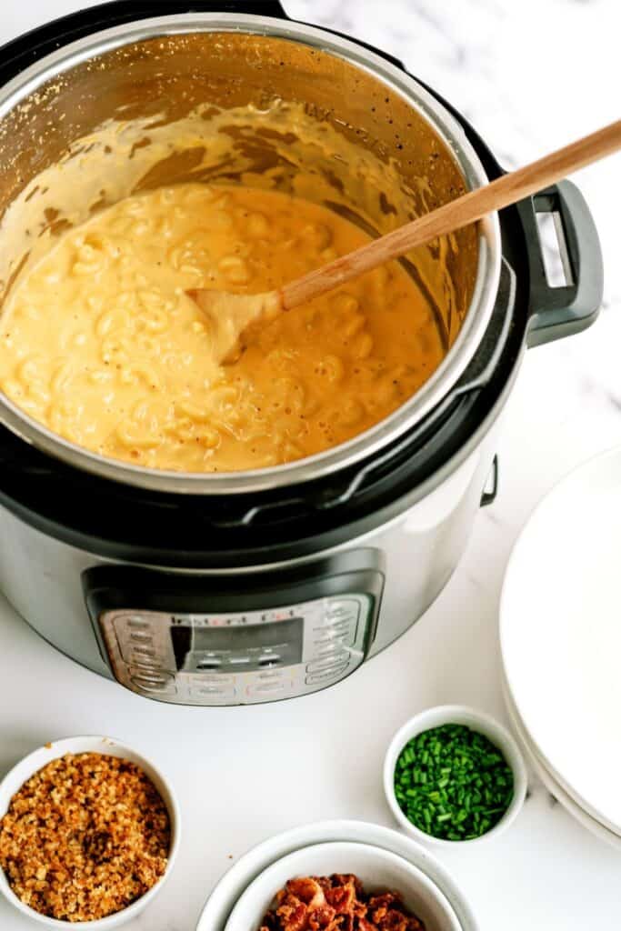 Instant Pot Loaded Mac and Cheese in the cooker with small side dishes.