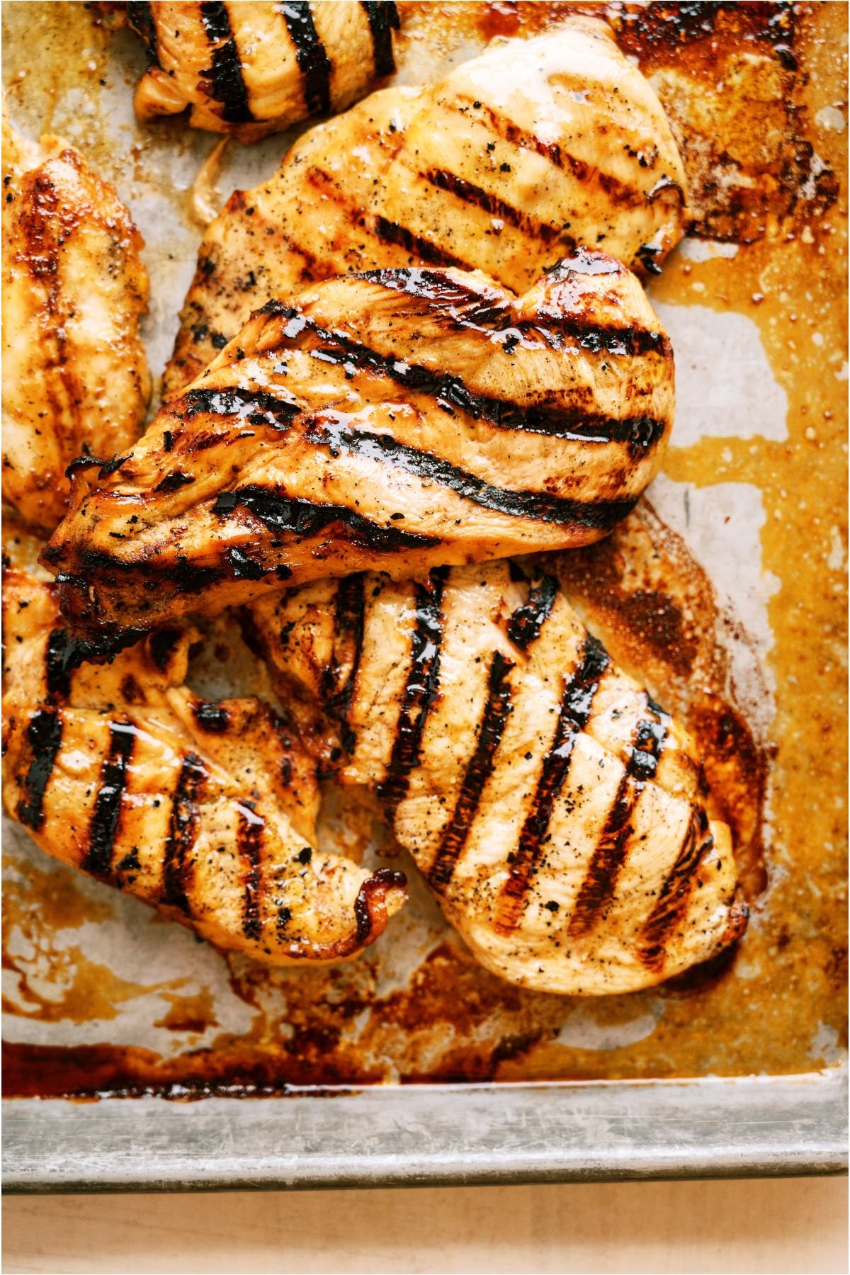 Marinated Grilled Chicken on a lined tray.