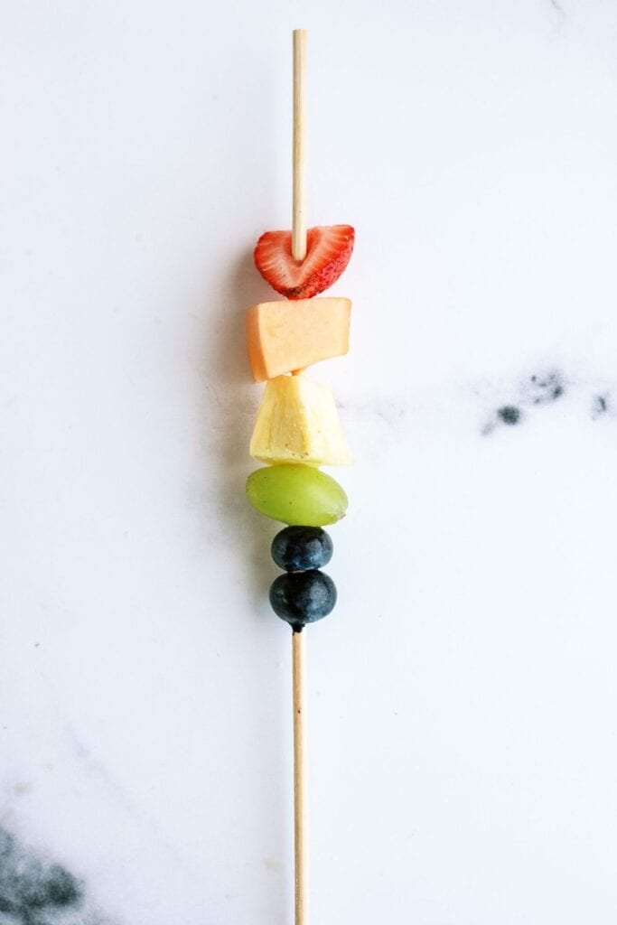 Rainbow Fruit Kabob on a white background.