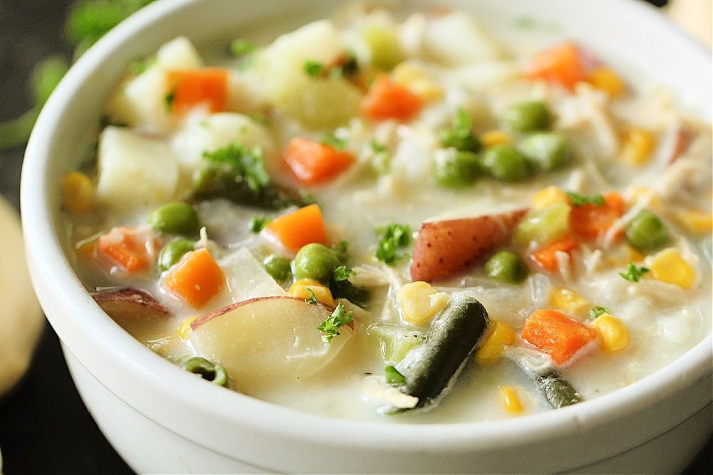 The best chicken pot pie soup in a white bowl