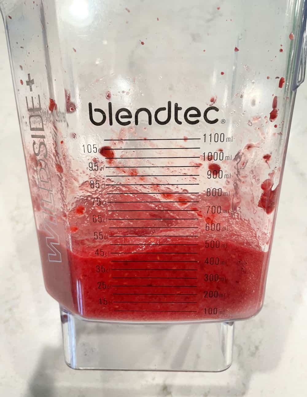 Raspberries, lemon juice and sugar blended inside of a blender.