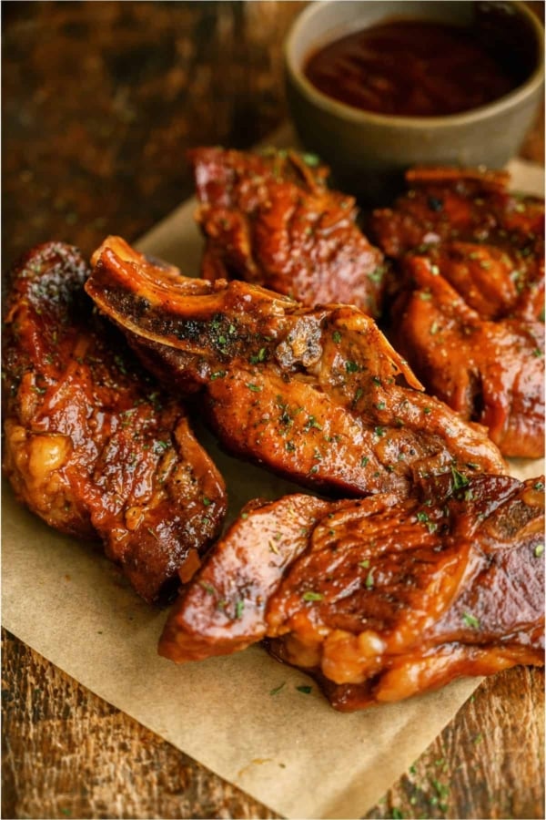 BBQ Slow Cooker Country Style Ribs on a parchment lined dish.