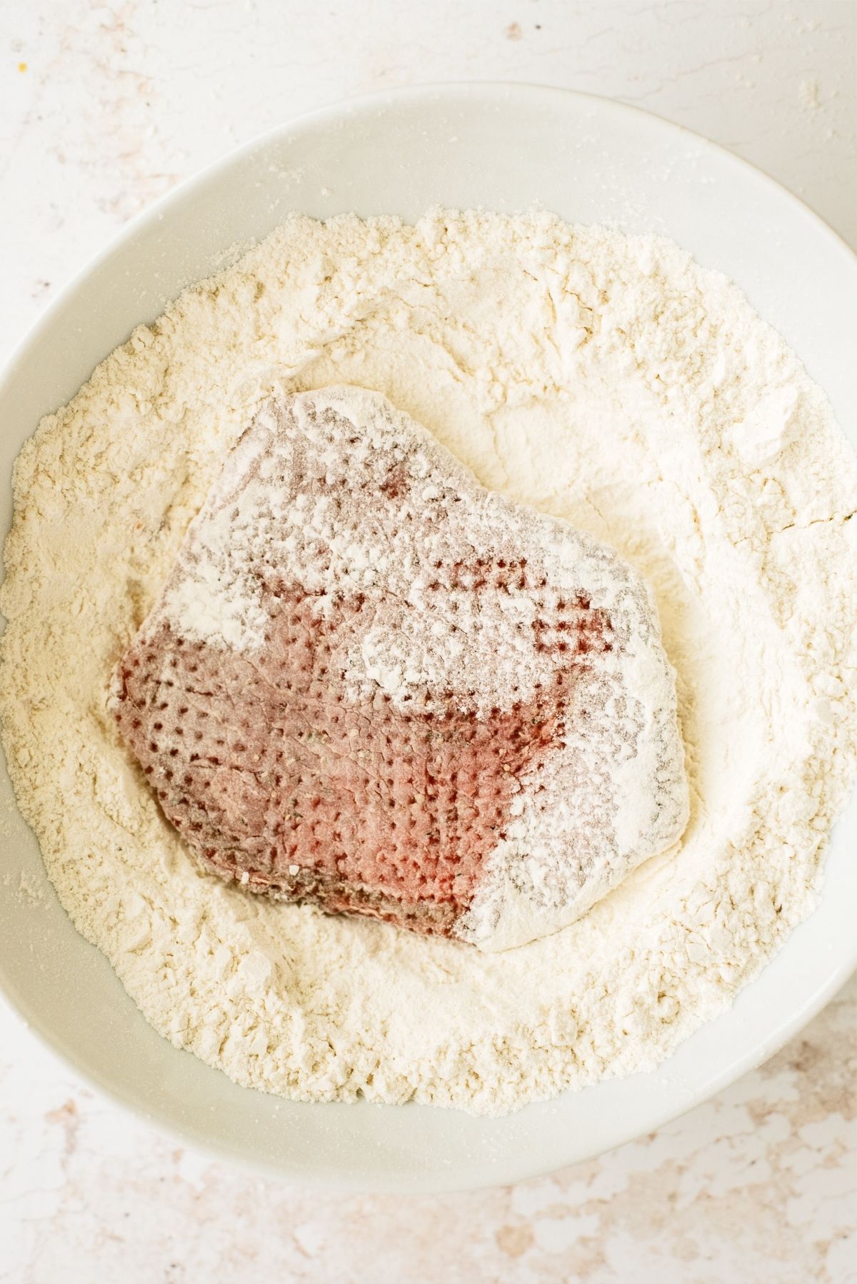 Tenderized meat dredged in flour