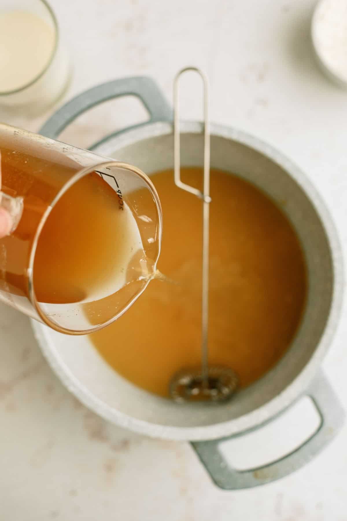 Gravy mixture in a pan with a whisk