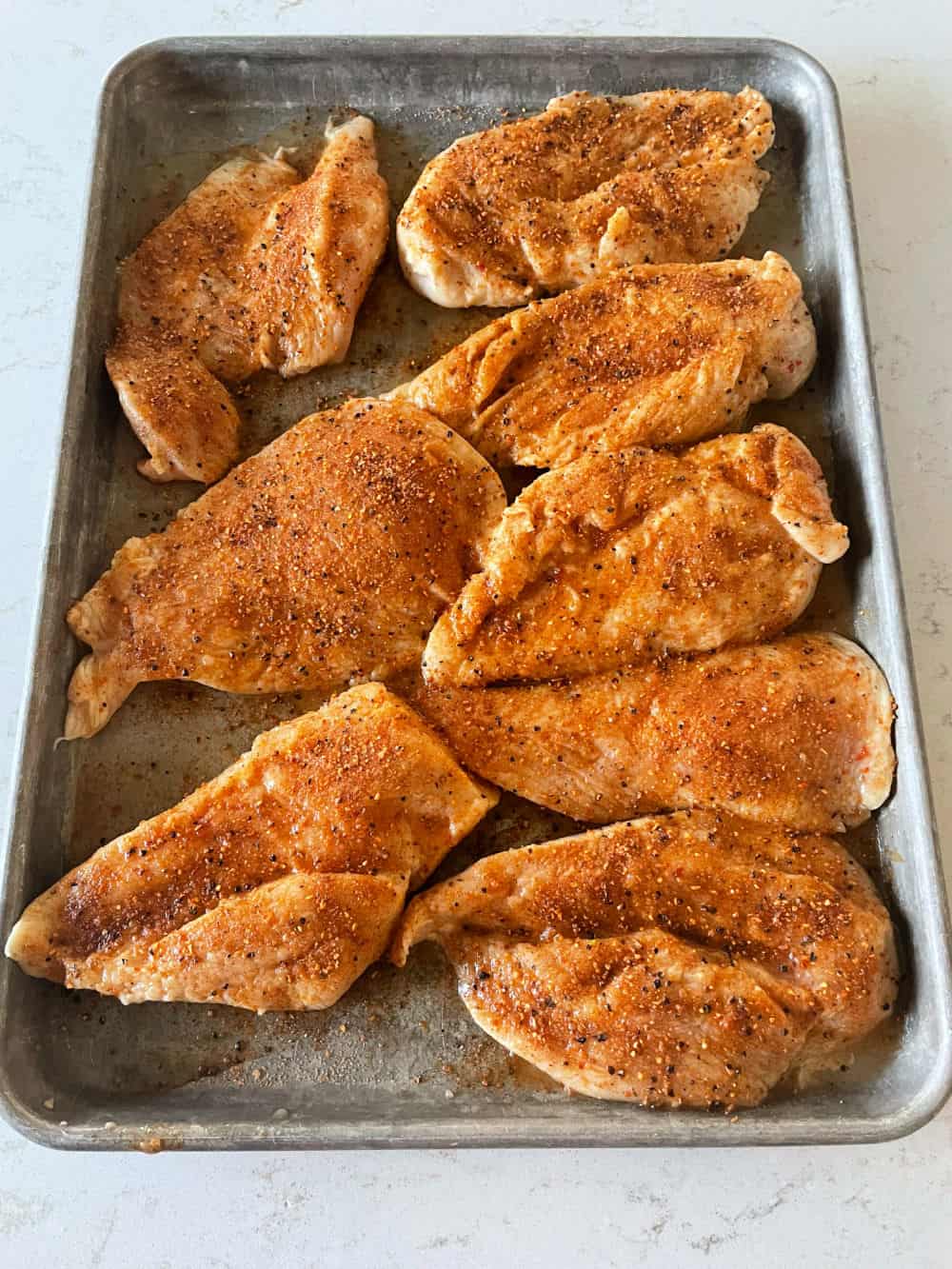 Chicken breast after marinating with rub on them